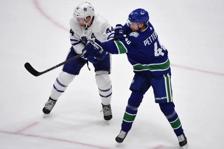 Dec 10, 2019; Vancouver, British Columbia, CAN; Toronto Maple Leafs defenseman Morgan Rielly (44) defends against Vancouver Canucks forward Elias Pettersson (40) during the third period at Rogers Arena