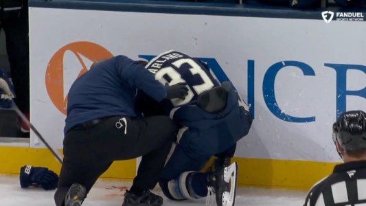 Connor Garland taking high stick from Seth Jarvis