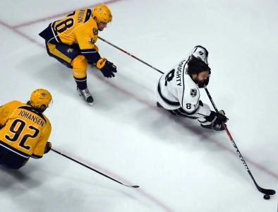Dec 22, 2016; Nashville, TN, USA; Los Angeles Kings defenseman Drew Doughty (8) skates away from pressure from Nashville Predators left wing Viktor Arvidsson (38) and center Ryan Johansen (92) during the first period at Bridgestone Arena.