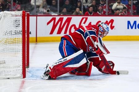 Mar 14, 2026; Montreal, Quebec, CAN; Montreal Canadiens goalie Jakub Dobes (75) makes a save against the San Jose Sharks during the first period at Bell Centre.