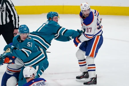 Apr 8, 2026; San Jose, California, USA; San Jose Sharks center Macklin Celebrini (71) and right wing Collin Graf (51) battle Edmonton Oilers center Connor McDavid (97) in the third period at SAP Center at San Jose.