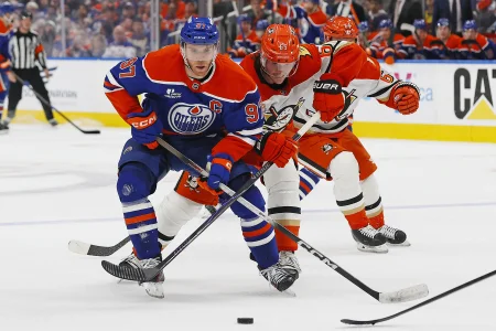 Apr 22, 2026; Edmonton, Alberta, CAN;Anaheim Ducks defensemen Jacob Trouba (65) tries to tie up the stick of Edmonton Oilers forward Connor McDavid (97) during the third period in game two of the first round of the 2026 Stanley Cup Playoffs at Rogers Place.