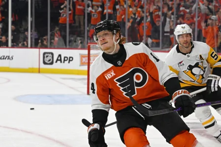 Apr 22, 2026; Philadelphia, Pennsylvania, USA; Philadelphia Flyers right wing Owen Tippett (74) celebrates his empty net goal against Pittsburgh Penguins defenseman Kris Letang (58) during the third period in game three of the first round of the 2026 Stanley Cup Playoffs at Xfinity Mobile Arena.