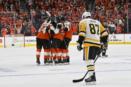 Apr 22, 2026; Philadelphia, Pennsylvania, USA; Philadelphia Flyers right wing Owen Tippett (74) celebrates his empty goal with teammates against Pittsburgh Penguins center Sidney Crosby (87) during the third period in game three of the first round of the 2026 Stanley Cup Playoffs at Xfinity Mobile Arena.