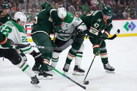 Apr 22, 2026; Saint Paul, Minnesota, USA; Minnesota Wild defenseman Jake Middleton (5), center Michael McCarron (47) and Dallas Stars left wing Jamie Benn (14) complete for the puck during the first period in game three of the first round of the 2026 Stanley Cup Playoffs at Grand Casino Arena.