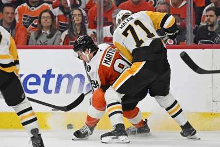 Apr 25, 2026; Philadelphia, Pennsylvania, USA; Philadelphia Flyers right wing Porter Martone (94) and Pittsburgh Penguins center Evgeni Malkin (71) battle for the puck during the first period in game four of the first round of the 2026 Stanley Cup Playoffs at Xfinity Mobile Arena.