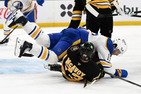 Apr 23, 2026; Boston, Massachusetts, USA; Buffalo Sabres center Peyton Krebs (19) collides with Boston Bruins defenseman Charlie McAvoy (73) during the second period of game three of the first round of the 2026 Stanley Cup Playoffs at the TD Garden. :