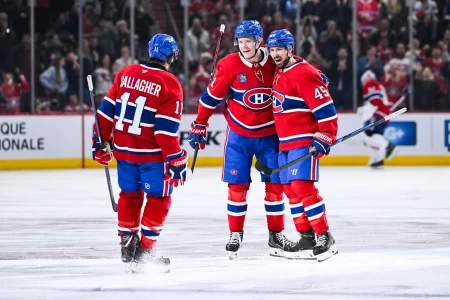 Mar 21, 2026; Montreal, Quebec, CAN; Montreal Canadiens defenseman Kaiden Guhle (21) celebrates with right wing Brendan Gallagher (11) and defenseman Alexandre Carrier (45) his goal against the New York Islanders during the third period at Bell Centre.