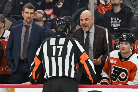 Jan 6, 2026; Philadelphia, Pennsylvania, USA; Philadelphia Flyers head coach Rick Tocchet speaks with referee Frederick LEcuyer (17) against the Anaheim Ducks during the third period at Xfinity Mobile Arena.