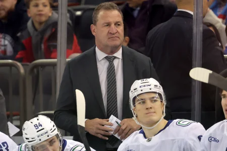 Dec 16, 2025; New York, New York, USA; Vancouver Canucks head coach Adam Foote coaches against the New York Rangers during the first period at Madison Square Garden.
