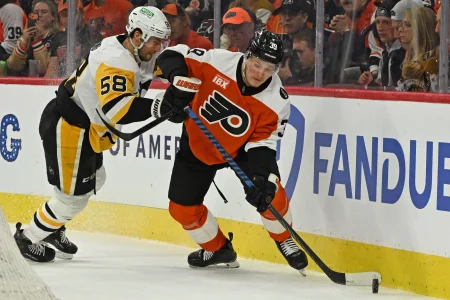 Apr 25, 2026; Philadelphia, Pennsylvania, USA; Philadelphia Flyers right wing Matvei Michkov (39) skates with the puck against Pittsburgh Penguins defenseman Kris Letang (58) during the first period in game four of the first round of the 2026 Stanley Cup Playoffs at Xfinity Mobile Arena.