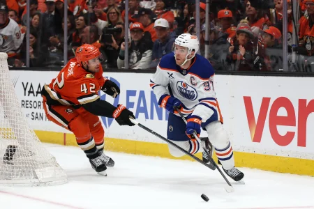 Apr 24, 2026; Anaheim, California, USA; Edmonton Oilers center Connor McDavid (97) controls the puck against Anaheim Ducks center Tim Washe (42) during the first period of game three of the first round of the 2026 Stanley Cup Playoffs at Honda Center.