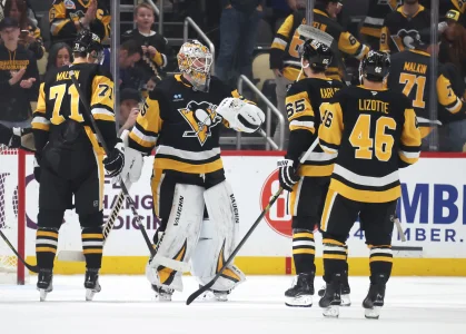 Mar 13, 2025; Pittsburgh, Pennsylvania, USA; Pittsburgh Penguins center Evgeni Malkin (71) and goaltender Tristan Jarry (35) and defenseman Erik Karlsson (65) and center Blake Lizotte (46) celebrate after defeating the St. Louis Blues at PPG Paints Arena.