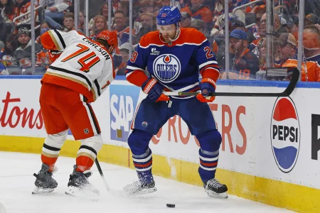 Apr 28, 2026; Edmonton, Alberta, CAN; Anaheim Ducks defensemen John Carlson (74) and Edmonton Oilers forward Leon Draisaitl (29) battle along the boards for a loose puck during the third period in game five of the first round of the 2026 Stanley Cup Playoffs at Rogers Place.