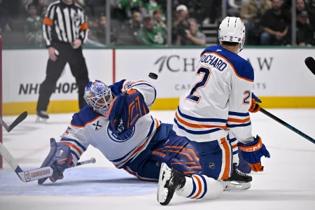 Mar 12, 2026; Dallas, Texas, USA; Edmonton Oilers goaltender Tristan Jarry (35) and defenseman Evan Bouchard (2) stops a Dallas Stars shot during the game between the Stars and the Oilers at the American Airlines Center