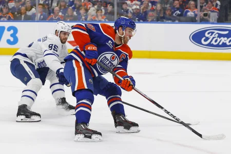 Feb 3, 2026; Edmonton, Alberta, CAN; Edmonton Oilers forward Connor McDavid (97) protects the puck from Toronto Maple Leafs defensemen Oliver Elman-Larsson (95) during the first period at Rogers Place.