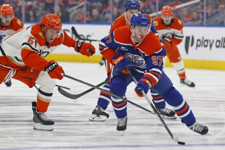 Apr 22, 2026; Edmonton, Alberta, CAN; Anaheim Ducks forward Cutter Gauthier (61) tries to knock the puck away from Edmonton Oilers forward Connor McDavid (97) during the first period in game two of the first round of the 2026 Stanley Cup Playoffs at Rogers Place.