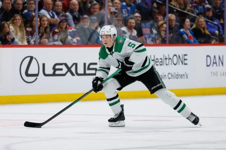 Mar 18, 2026; Denver, Colorado, USA; Dallas Stars defenseman Nils Lundkvist (5) controls the puck in the first period against the Colorado Avalanche at Ball Arena.