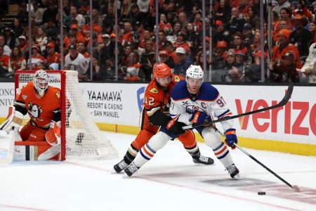 Apr 24, 2026; Anaheim, California, USA; Edmonton Oilers center Connor McDavid (97) fights for the puck against Anaheim Ducks center Tim Washe (42) during the first period of game three of the first round of the 2026 Stanley Cup Playoffs at Honda Center.