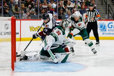 Feb 26, 2026; Denver, Colorado, USA; Colorado Avalanche right wing Valeri Nichushkin (13) controls the puck under pressure from Minnesota Wild left wing Kirill Kaprizov (97) as goaltender Filip Gustavsson (32) defends in the second period at Ball Arena.