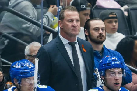 Sep 26, 2025; Vancouver, British Columbia, CAN; Vancouver Canucks head coach Adam Foote on the bench against the Seattle Kraken in the first period at Rogers Arena.