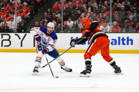 Apr 30, 2026; Anaheim, California, USA; Edmonton Oilers center Connor McDavid (97) and Anaheim Ducks defenseman Radko Gudas (7) battle for the puck in the first period of game six of the first round of the 2026 Stanley Cup Playoffs at Honda Center.