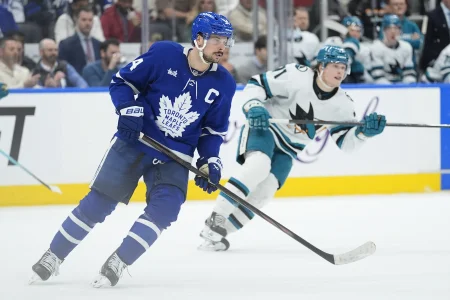 Dec 11, 2025; Toronto, Ontario, CAN; Toronto Maple Leafs forward Auston Matthews (34) and San Jose Sharks forward Macklin Celebrini (71) skate after the puck during the second period at Scotiabank Arena.