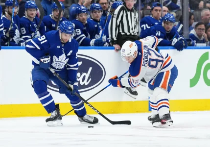 Dec 13, 2025; Toronto, Ontario, CAN; Toronto Maple Leafs center John Tavares (91) battles for the puck with Edmonton Oilers right wing Vasily Podkolzin (92) during the second period at Scotiabank Arena.