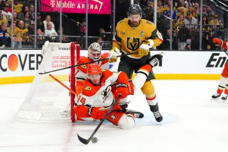 May 4, 2026; Las Vegas, Nevada, USA; Anaheim Ducks defenseman Drew Helleson (14) falls after clearing the puck away from Vegas Golden Knights right wing Mark Stone (61) during the third period of game one of the second round of the 2026 Stanley Cup Playoffs at T-Mobile Arena.