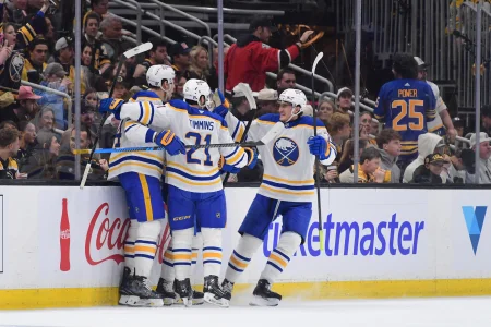 Apr 26, 2026; Boston, Massachusetts, USA; Buffalo Sabres defenseman Logan Stanley (64) defenseman Conor Timmins (21) and center Tage Thompson (72) celebrate a goal during the first period in game four of the first round of the 2026 Stanley Cup Playoffs against the Boston Bruins at TD Garden.