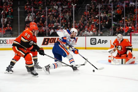 Apr 30, 2026; Anaheim, California, USA; Edmonton Oilers center Connor McDavid (97) handles the puck against Anaheim Ducks defenseman Pavel Mintyukov (98) defenseman John Carlson (74) and goaltender Lukas Dostal (1) in the first period of game six of the first round of the 2026 Stanley Cup Playoffs at Honda Center.