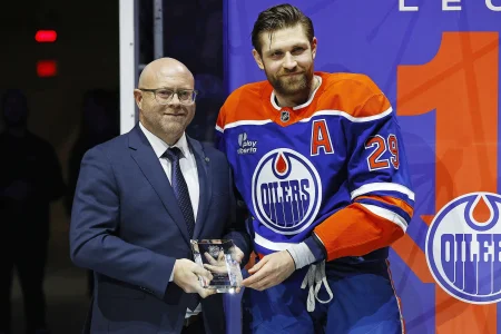 Jan 10, 2026; Edmonton, Alberta, CAN; Edmonton Oilers GM Stan Bowman presents Leon Draisaitl with a Tiffany Crystal for recording 1000 points in the NHL at Rogers Place.