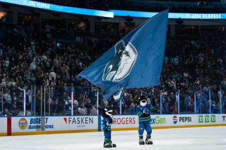 Apr 14, 2026; Vancouver, British Columbia, CAN; Fin the mascot and the Vancouver Canucks celebrate their victory against the Los Angeles Kings at Rogers Arena.