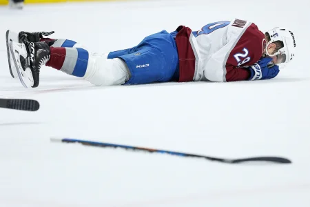 May 11, 2026; Saint Paul, Minnesota, USA; Colorado Avalanche center Nathan MacKinnon (29) lies on the ice after during the second period in game four of the second round of the 2026 Stanley Cup Playoffs against the Minnesota Wild at Grand Casino Arena.