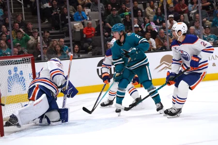 Apr 8, 2026; San Jose, California, USA; San Jose Sharks center Will Smith (2) shoots the puck against Edmonton Oilers goalie Connor Ingram (39) as Edmonton Oilers defenseman Evan Bouchard (2) helps on defense during the second period at SAP Center at San Jose.