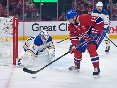 May 10, 2026; Montreal, Quebec, CAN; Buffalo Sabres goalie Alex Lyon (34) stops Montreal Canadiens forward Nick Suzuki (14) during the first period in game three of the second round of the 2026 Stanley Cup Playoffs at the Bell Centre.