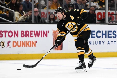 Apr 11, 2026; Boston, Massachusetts, USA; Boston Bruins defenseman Charlie McAvoy (73) attempts a shot against the Tampa Bay Lightning during the first period at the TD Garden.