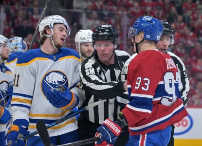 May 12, 2026; Montreal, Quebec, CAN; linesmen Julien Fournier (56) and Matt MacPherson (83) step in between Buffalo Sabres forward Josh Doan (91) and Montreal Canadiens forward Ivan Demidov (93) during the third period in game four of the second round of the 2026 Stanley Cup Playoffs at Bell Centre.
