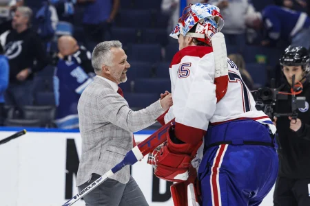 May 3, 2026; Tampa, Florida, USA; the Montreal Canadiens head coach Martin St. Louis and goalie Jakub Dobes (75) react to beating the Tampa Bay Lightning in game seven of the first round of the 2026 Stanley Cup Playoffs at Benchmark International Arena.