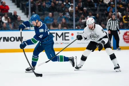 Apr 14, 2026; Vancouver, British Columbia, CAN; Los Angeles Kings forward Adrian Kempe (9) stick checks Vancouver Canucks forward Elias Pettersson (40) while shooting in the third period at Rogers Arena.