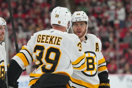 Apr 7, 2026; Raleigh, North Carolina, USA; Boston Bruins center Morgan Geekie (39) celebrates his goal with right wing David Pastrnak (88) against the Carolina Hurricanes during the second period at Lenovo Center.