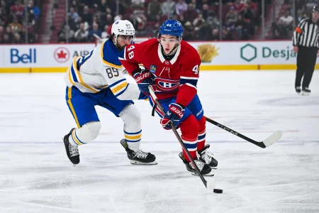 Dec 17, 2024; Montreal, Quebec, CAN; Montreal Canadiens defenseman Lane Hutson (48) plays the puck agianst Buffalo Sabres right wing Alex Tuch (89) during the second period at Bell Centre.