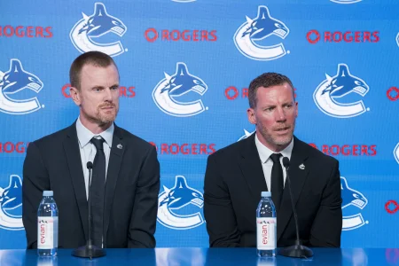 May 14, 2026; Vancouver, BC, Canada; The Vancouver Canucks promoted Henrik Sedin (not pictured) and his twin brother Daniel Sedin (left) to co-presidents and Ryan Johnson (right) was named the Canucks new general manger during a press conference at Rogers Arena.