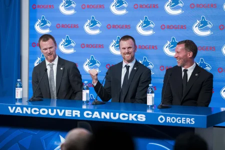 May 14, 2026; Vancouver, BC, Canada; The Vancouver Canucks promoted Henrik Sedin (left) and his twin brother Daniel Sedin (center) to co-presidents and Ryan Johnson (right) was named the Canucks new general manger during a press conference at Rogers Arena.