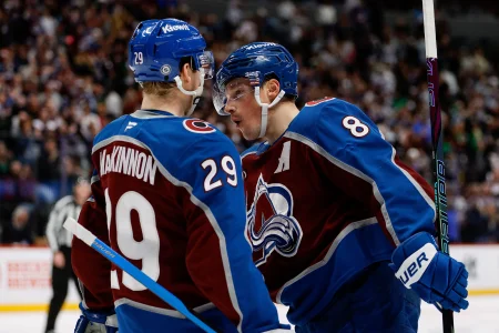 Jan 2, 2025; Denver, Colorado, USA; Colorado Avalanche defenseman Cale Makar (8) celebrates his goal with center Nathan MacKinnon (29) in the second period against the Buffalo Sabres at Ball Arena.