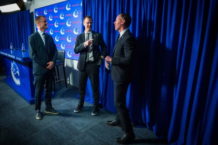 May 14, 2026; Vancouver, BC, Canada; Daniel Sedin and Henrik Sedin and Ryan Johnson smile after a press conference where the Vancouver Canucks name new senior management staff. Henrik Sedin and his twin brother Daniel Sedin have been appointed as co-presidents of hockey operations and Ryan Johnson is now the new general manager of the club at Rogers Arena.
