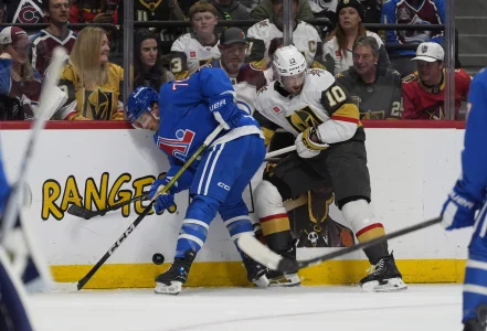 Apr 11, 2026; Denver, Colorado, USA; Colorado Avalanche defenseman Sam Malinski (70) and Vegas Golden Knights center Colton Sissons (10) battle for the puck in the first period at Ball Arena.