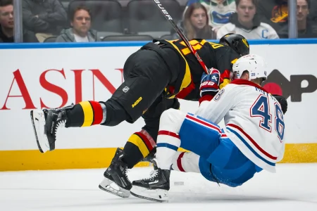 Oct 25, 2025; Vancouver, British Columbia, CAN; Vancouver Canucks forward Kiefer Sherwood (44) checks Montreal Canadiens defenseman Lane Hutson (48) in the second period at Rogers Arena.