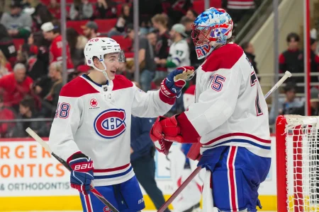 Jan 1, 2026; Raleigh, North Carolina, USA; Montréal Canadiens goaltender Jakub Dobes (75) and Montréal Canadiens defenseman Lane Hutson (48) celebrates their victory against the Carolina Hurricanes at Lenovo Center.