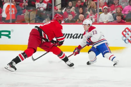 Mar 29, 2026; Raleigh, North Carolina, USA; Montreal Canadiens right wing Cole Caufield (13) stops in front of Carolina Hurricanes defenseman Kandre Miller (19) during the second period at Lenovo Center.